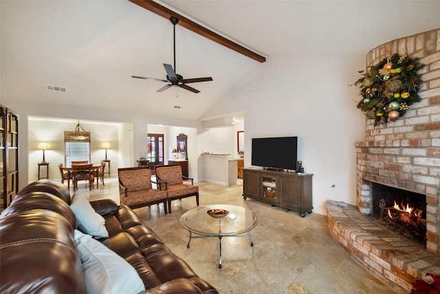 living room with vaulted ceiling with beams, ceiling fan, and a brick fireplace