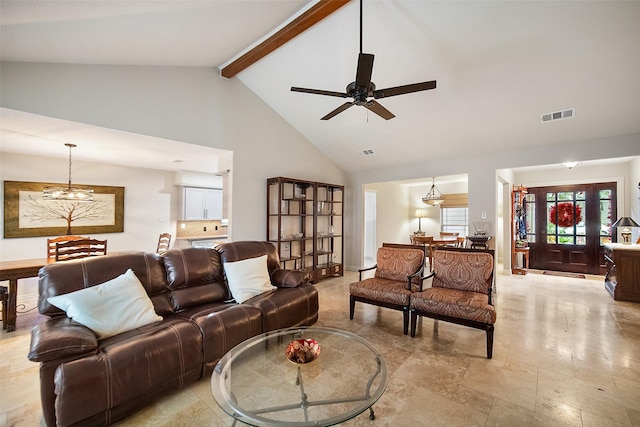 living room with ceiling fan with notable chandelier, beam ceiling, and high vaulted ceiling