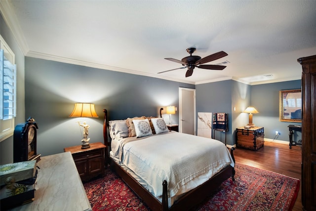 bedroom featuring dark hardwood / wood-style floors, ceiling fan, and crown molding