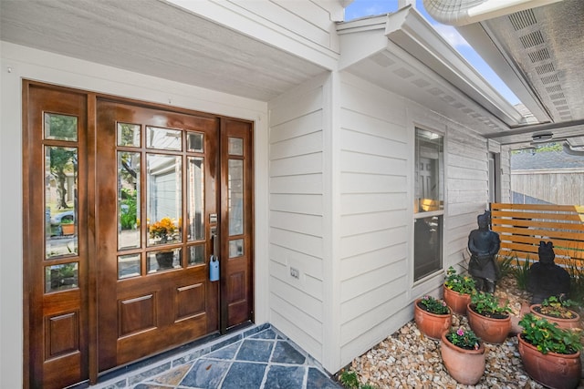 view of exterior entry featuring a porch