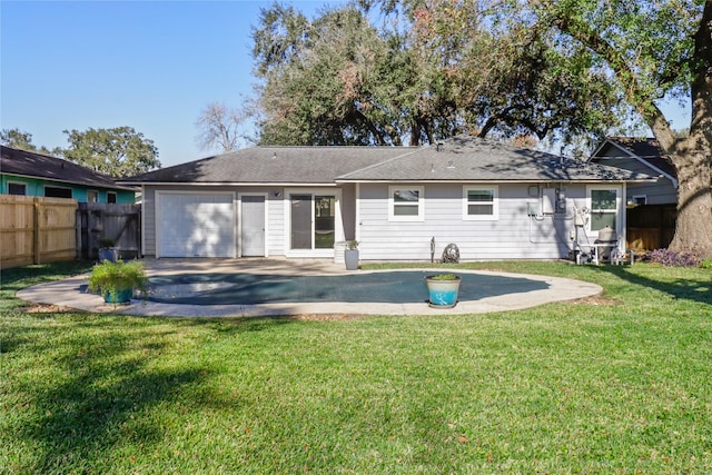 rear view of property featuring a yard and a patio area