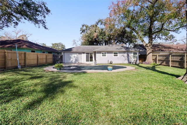 back of property with a patio area and a yard