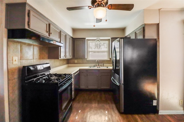 kitchen with dark wood-type flooring, ceiling fan, sink, and black appliances