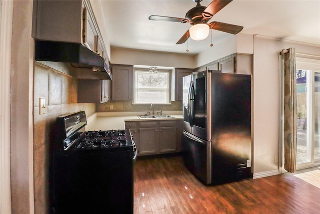 kitchen with black appliances, ceiling fan, dark hardwood / wood-style flooring, and sink