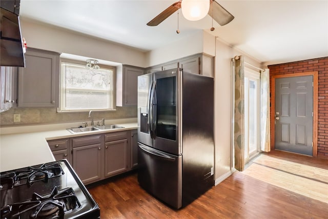 kitchen with stainless steel fridge with ice dispenser, gray cabinets, dark hardwood / wood-style floors, and sink