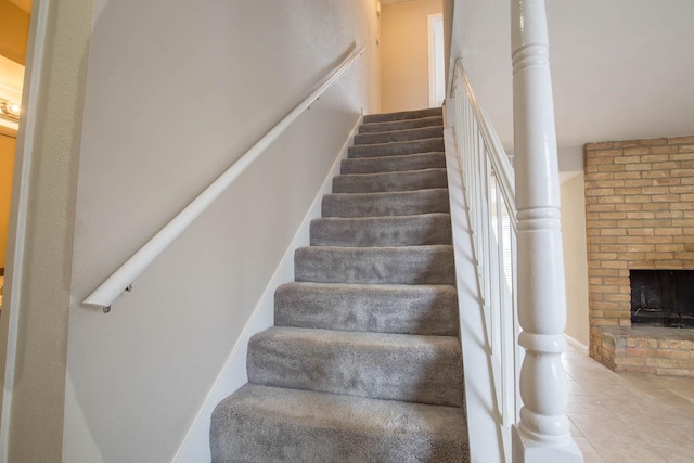 stairway featuring a fireplace