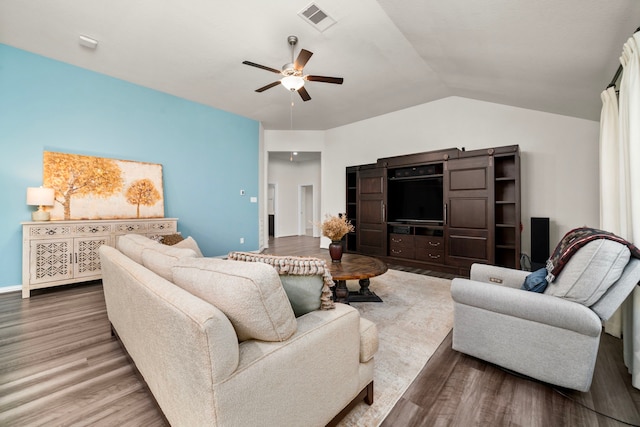 living room with ceiling fan, vaulted ceiling, and hardwood / wood-style flooring