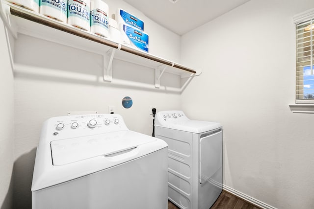 laundry area with independent washer and dryer and dark wood-type flooring