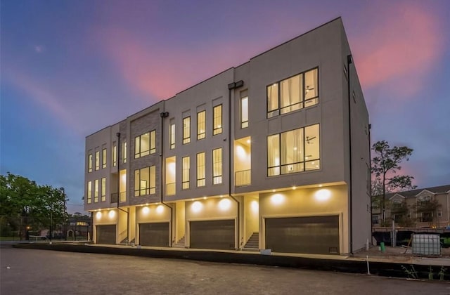 outdoor building at dusk with a garage