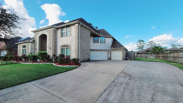 view of front facade featuring a garage and a front lawn