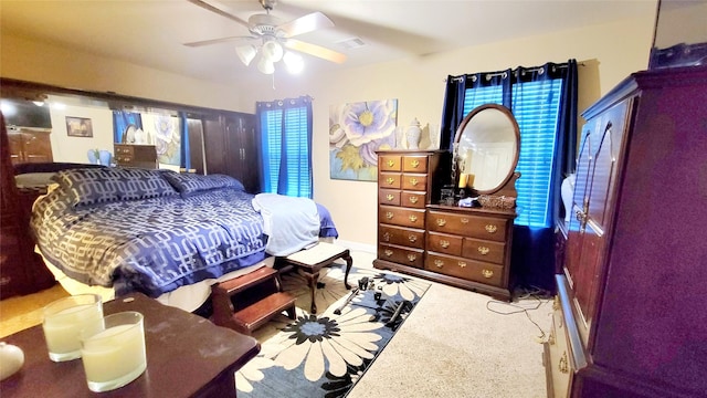 bedroom featuring ceiling fan and carpet