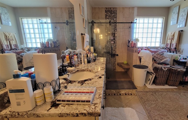 bathroom with tile patterned flooring, vanity, and an enclosed shower