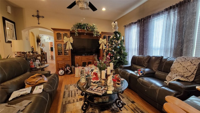 living room with ceiling fan and light hardwood / wood-style flooring