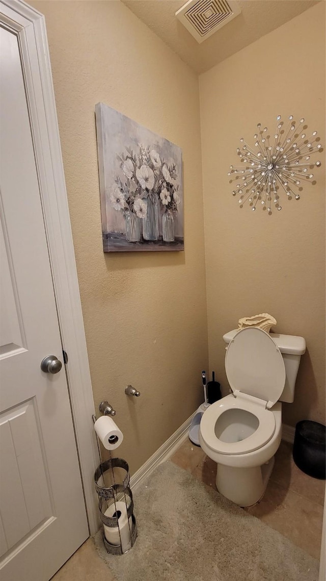 bathroom featuring tile patterned flooring and toilet