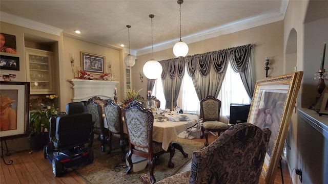 dining room featuring hardwood / wood-style flooring and ornamental molding