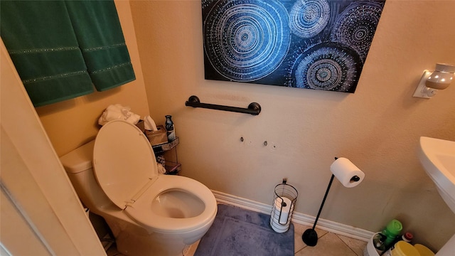 bathroom with toilet and tile patterned floors