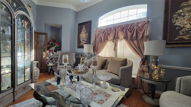 living area featuring crown molding and hardwood / wood-style floors