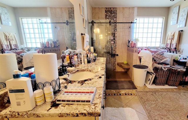 bathroom with tile patterned floors, an enclosed shower, and vanity