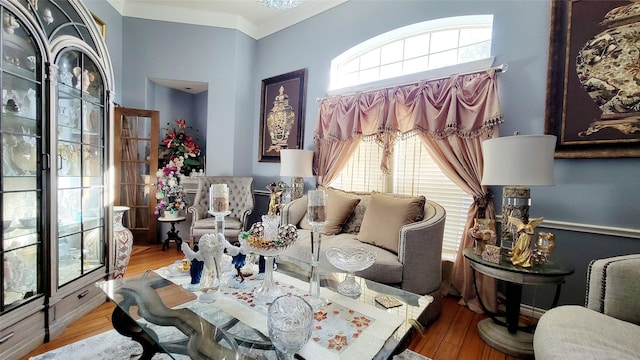 sitting room featuring hardwood / wood-style flooring, a healthy amount of sunlight, and ornamental molding