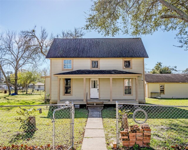 view of front of property with a porch and a front lawn