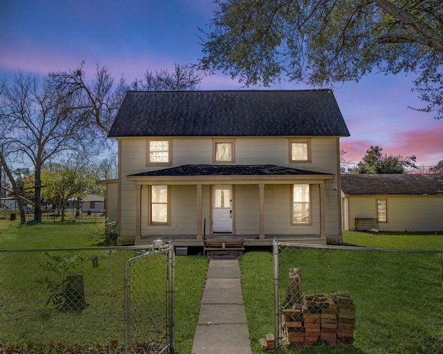 view of front facade featuring covered porch and a lawn