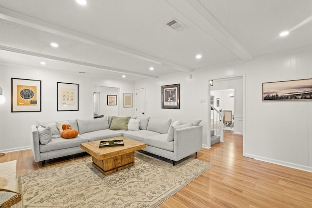 living room with beam ceiling and light hardwood / wood-style flooring