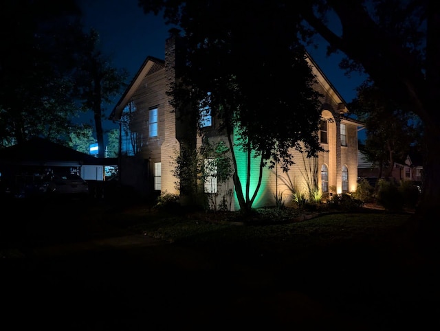 property exterior at night with a garage