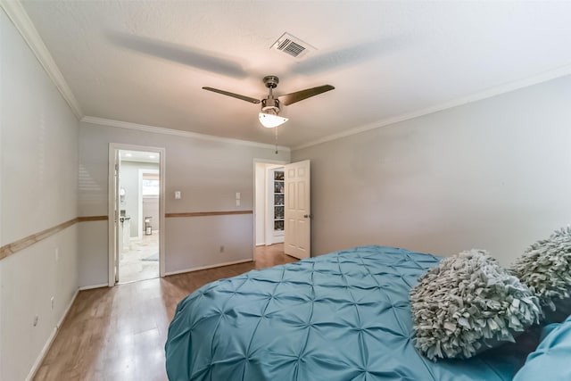 bedroom with ornamental molding, hardwood / wood-style floors, and ceiling fan