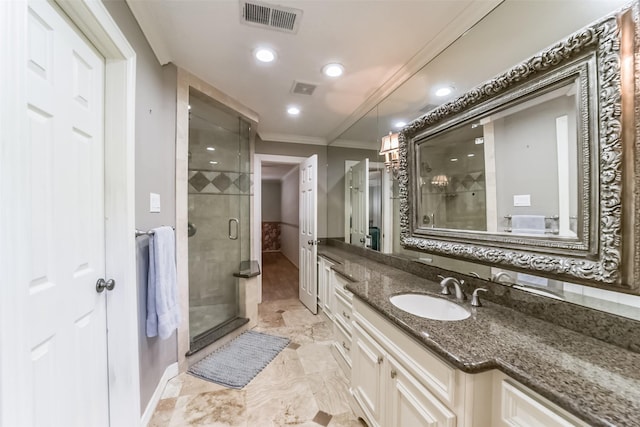 bathroom with ornamental molding, vanity, and an enclosed shower