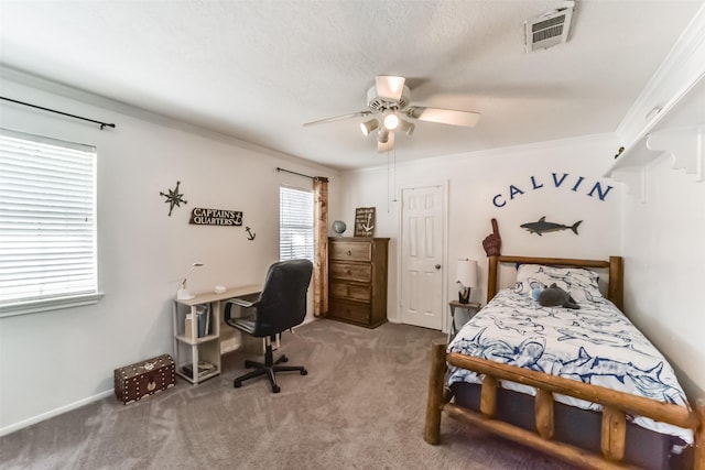 bedroom with crown molding, ceiling fan, and carpet