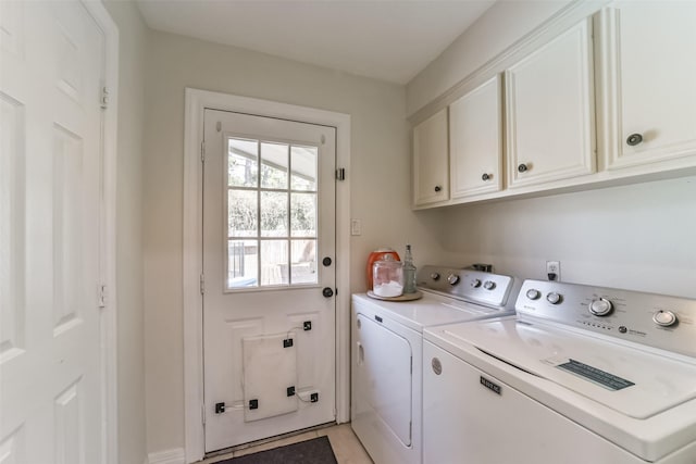 clothes washing area featuring independent washer and dryer, light tile patterned floors, and cabinets