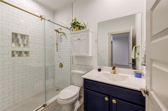 bathroom featuring vanity, an enclosed shower, and toilet