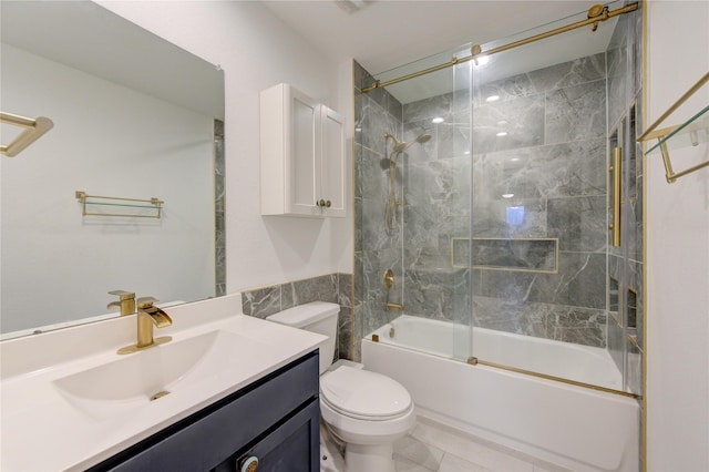 full bathroom featuring combined bath / shower with glass door, vanity, toilet, and tile patterned flooring