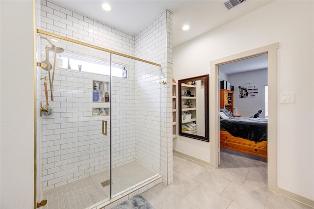 bathroom with tile patterned floors and a shower with shower door