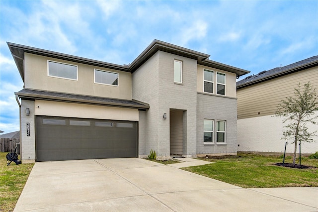 view of front facade featuring a front yard and a garage