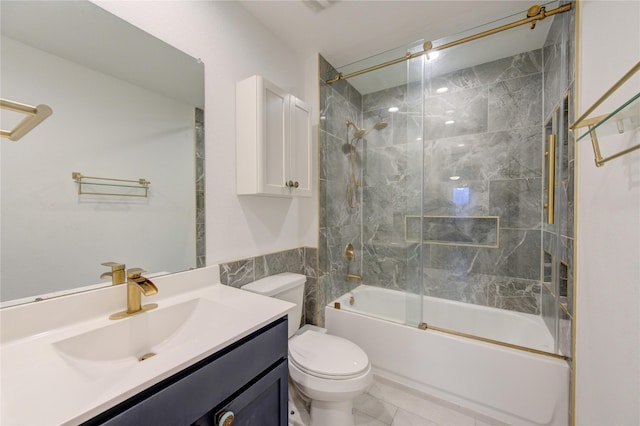 full bathroom with tile patterned floors, toilet, vanity, and combined bath / shower with glass door