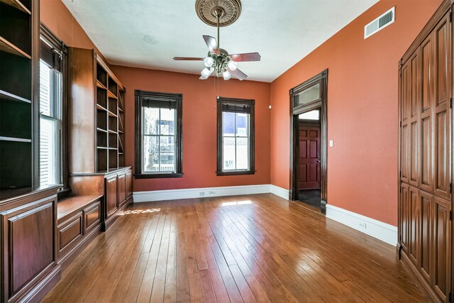 interior space with dark hardwood / wood-style floors and ceiling fan