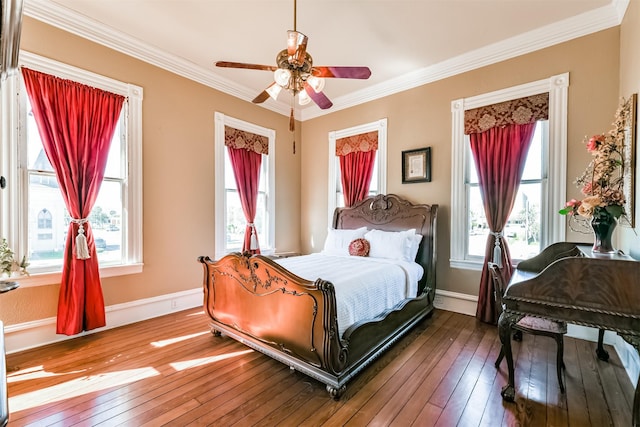 bedroom featuring hardwood / wood-style flooring, ceiling fan, and crown molding