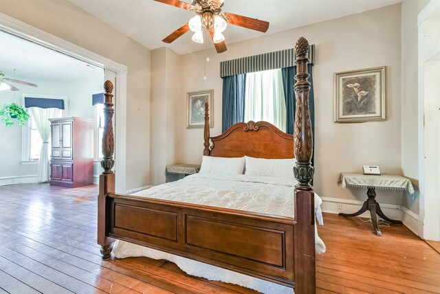 bedroom with light hardwood / wood-style flooring and ceiling fan