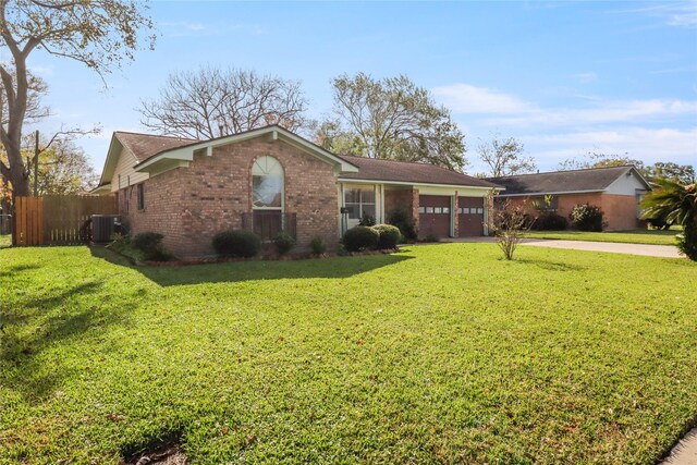 ranch-style house with a front yard, a garage, and central AC