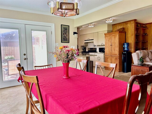 dining space featuring plenty of natural light, light colored carpet, french doors, and ornamental molding