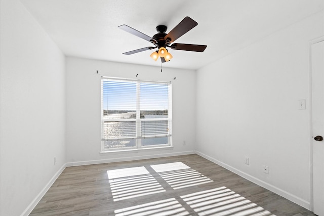 empty room with light hardwood / wood-style floors and ceiling fan