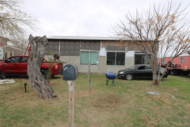 view of front of house with a front lawn and stucco siding