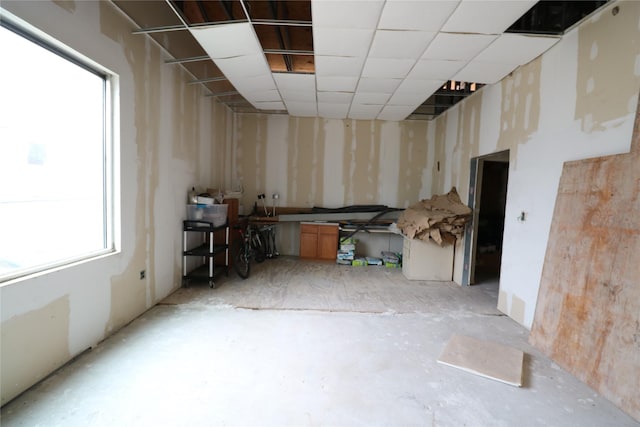 interior space with a paneled ceiling