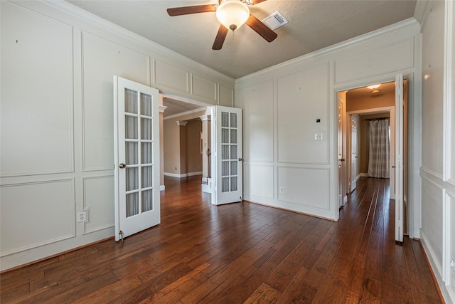 empty room featuring crown molding, dark hardwood / wood-style floors, french doors, and ceiling fan