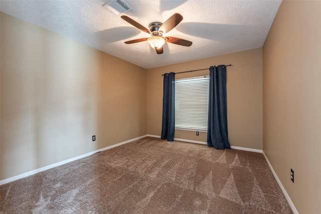 unfurnished room with ceiling fan, light colored carpet, and a textured ceiling