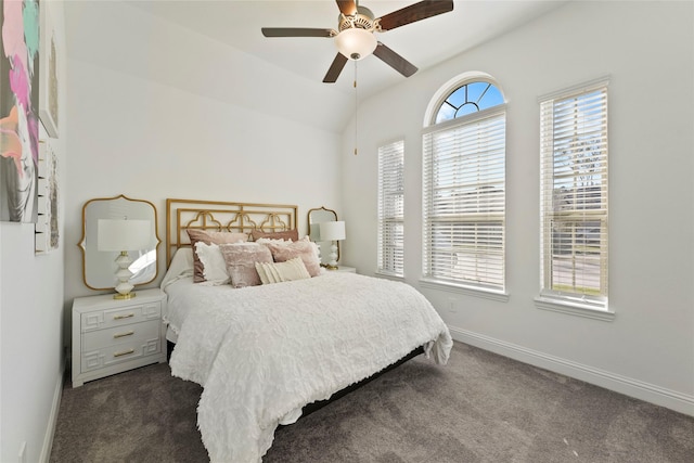 bedroom with ceiling fan, dark carpet, and lofted ceiling