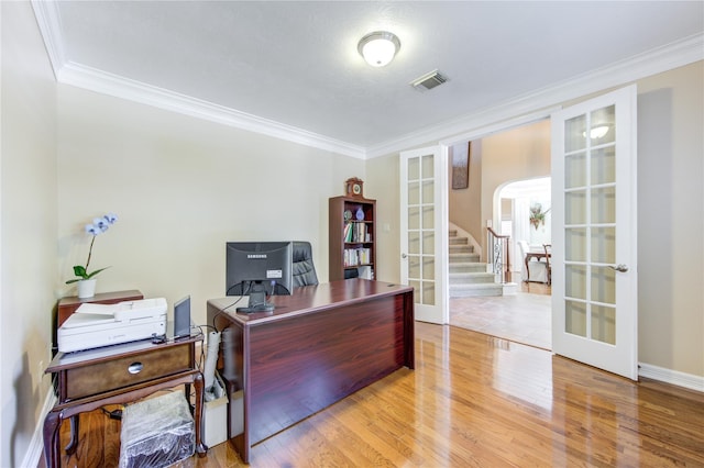 office with french doors, light wood-type flooring, and ornamental molding