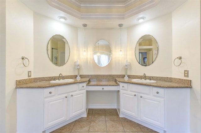 bathroom featuring tile patterned flooring, vanity, ornamental molding, and a tray ceiling