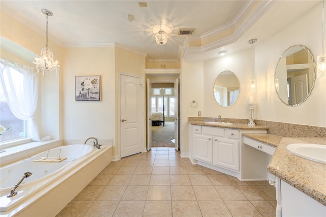 bathroom with tile patterned floors, ornamental molding, vanity, an inviting chandelier, and a bathing tub